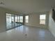 Bright living room featuring sliding glass doors that lead to an outdoor patio at 9819 Gobat Aly, Orlando, FL 32827