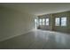 Spacious living room with expansive windows, bright light, and modern, light-colored tile flooring at 9819 Gobat Aly, Orlando, FL 32827