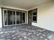 Covered patio featuring sleek tiled flooring, sliding glass doors, and ample space for outdoor enjoyment at 9819 Gobat Aly, Orlando, FL 32827
