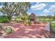 Brick fireplace and seating area near a pond at 1102 Eagles Pass Way, Winter Garden, FL 34787