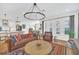 Spacious living room featuring a leather sofa and large chandelier at 1102 Eagles Pass Way, Winter Garden, FL 34787