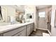 Elegant bathroom with double vanity, large mirror, and walk-in shower at 1107 Tropea Ln, Auburndale, FL 33823