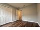 Spacious bedroom with double door closet and wood-look flooring at 1107 Tropea Ln, Auburndale, FL 33823