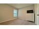 Bright bedroom featuring a large window and plush carpeting at 1107 Tropea Ln, Auburndale, FL 33823