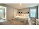 Main bedroom with a large bed, built-in drawers, and an ensuite at 1107 Tropea Ln, Auburndale, FL 33823