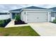 Newly constructed home with a two-car garage and well-manicured lawn at 1107 Tropea Ln, Auburndale, FL 33823