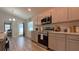 Modern kitchen with stainless steel appliances and an eat-in area at 1107 Tropea Ln, Auburndale, FL 33823
