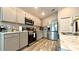 Modern kitchen with stainless steel appliances and grey cabinets at 1107 Tropea Ln, Auburndale, FL 33823