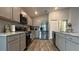 Modern kitchen with stainless steel appliances and an island at 1107 Tropea Ln, Auburndale, FL 33823
