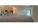 Open-concept living room showcases a kitchen with stainless steel appliances and a breakfast bar at 1107 Tropea Ln, Auburndale, FL 33823