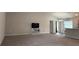 Spacious living room with carpeted floor and TV stand at 1107 Tropea Ln, Auburndale, FL 33823