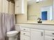 Clean bathroom with white vanity, cabinets and striped shower curtain at 12061 Greco Dr, Orlando, FL 32824