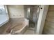 Bathroom with corner soaking tub and walk-in shower at 12061 Greco Dr, Orlando, FL 32824