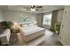 Virtually staged main bedroom with king-size bed and modern decor at 12061 Greco Dr, Orlando, FL 32824