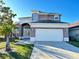 Two-story house with a two-car garage and landscaped lawn at 12061 Greco Dr, Orlando, FL 32824