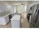 Modern kitchen with white cabinets, island, and breakfast nook at 12061 Greco Dr, Orlando, FL 32824