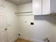 Laundry room with washer and dryer hookups and overhead storage at 12061 Greco Dr, Orlando, FL 32824