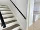 Modern staircase with gray wood-look treads and white risers at 12061 Greco Dr, Orlando, FL 32824