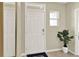 Bright entryway with white door and mirror at 1300 Cascades Ave, Davenport, FL 33837