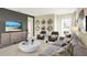 Bright living room features stylish gray sofas and a large TV at 1300 Cascades Ave, Davenport, FL 33837