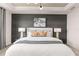 Main bedroom features a large bed, dark accent wall, and modern nightstands at 13636 Fresh Ivy St, Winter Garden, FL 34787