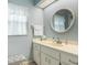 Comfortable bathroom featuring a single sink vanity with white cabinets, a large mirror, and soft blue walls at 1433 Lake Marion Dr, Apopka, FL 32712