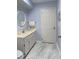 Bright bathroom featuring stylish gray tile flooring, a modern vanity, and a round mirror at 1433 Lake Marion Dr, Apopka, FL 32712