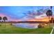 Beautiful water view at sunset, showcasing the vibrant colors of the sky and the serene landscape at 1433 Lake Marion Dr, Apopka, FL 32712
