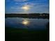 Night water view reflecting moonlight with a peaceful ambiance and lush surroundings at 1433 Lake Marion Dr, Apopka, FL 32712