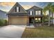 Two-story house with a large driveway and landscaped yard at 1624 Valmont Ln, Apopka, FL 32703