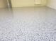This garage features durable, speckled flooring for easy maintenance and longevity at 1624 Valmont Ln, Apopka, FL 32703
