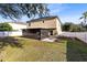 Tan two-story house with screened porch and yard at 1624 Valmont Ln, Apopka, FL 32703