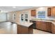 Open kitchen with island, hardwood floors, and view of living room at 1624 Valmont Ln, Apopka, FL 32703