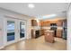 Traditional kitchen with center island, black appliances, and direct backyard access at 1624 Valmont Ln, Apopka, FL 32703