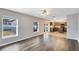 Bright living room features hardwood floors with kitchen view at 1624 Valmont Ln, Apopka, FL 32703