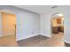 Open living room with hardwood floors and neutral paint; staircase and kitchen view at 1624 Valmont Ln, Apopka, FL 32703
