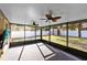 Enclosed patio with ceiling fans and view of the backyard with vinyl privacy fence at 1624 Valmont Ln, Apopka, FL 32703