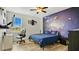 Bedroom with a space-themed mural and comfortable bed at 1760 Horseshoe Creek Road, Davenport, FL 33837