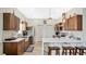 Modern kitchen with wooden cabinetry, marble countertops, and a breakfast bar at 1760 Horseshoe Creek Road, Davenport, FL 33837