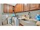 Laundry room with wooden cabinets, a farmhouse sink, and washer/dryer at 1760 Horseshoe Creek Road, Davenport, FL 33837