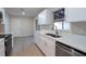 White kitchen with stainless steel appliances and double sink at 217 Bentbough Dr, Leesburg, FL 34748