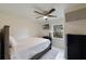 Cozy bedroom with a double bed, ceiling fan, and mini-fridge at 2441 Church St, Sanford, FL 32771