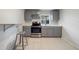 Modern kitchen with gray cabinets, stainless steel appliances, and breakfast bar at 2441 Church St, Sanford, FL 32771