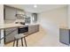 Modern kitchen with gray cabinets, stainless steel appliances, and breakfast bar at 2441 Church St, Sanford, FL 32771