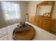 Bedroom with a queen bed, dresser, and large window at 2530 Saffron Ln, The Villages, FL 32162