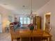 Dining room with wood table and chairs, view to living room at 2530 Saffron Ln, The Villages, FL 32162