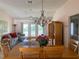 Dining room with wood table and chairs, and view to living room at 2530 Saffron Ln, The Villages, FL 32162