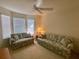 Guest bedroom with two sofas and large windows at 2530 Saffron Ln, The Villages, FL 32162