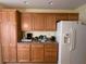 Kitchen with wood cabinets and appliances at 2530 Saffron Ln, The Villages, FL 32162