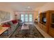 Spacious living room with patio access and wood cabinet at 2530 Saffron Ln, The Villages, FL 32162